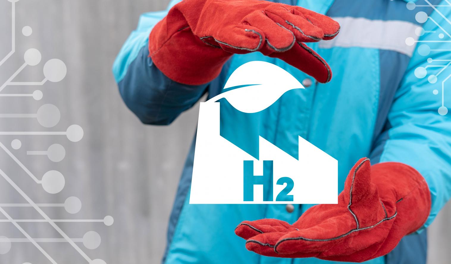 Arbeiter mit roten Handschuhen hält virtuelles H2 Logo zwischen seinen Händen.