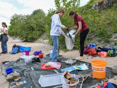 Kinder sammeln Müll am Strand